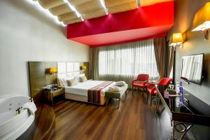 a hotel room with a bed and a bath tub at Park Inn by Radisson Istanbul Asia Kavacik in Istanbul