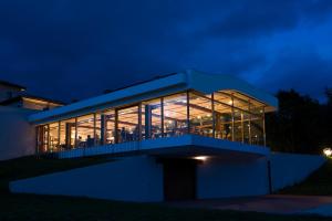 a building with large glass windows at night at Cincinnato Wine Resort in Cori