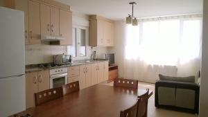 a kitchen with a table and a dining room at Apartamentos Alejandra in Barreiros