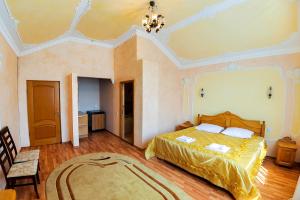 a bedroom with a bed and a chandelier at Shklo Motel in Shklo