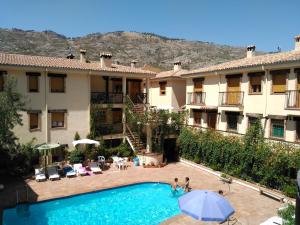 a view of a hotel with a swimming pool at Apartamentos Valle del Guadalquivir in Arroyo Frio