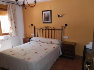 a bedroom with a bed with a white bedspread at Apartamentos Valle del Guadalquivir in Arroyo Frio +132 photos