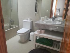 a bathroom with a toilet and a sink at Villa Cristina in Puerto del Carmen +11 photos