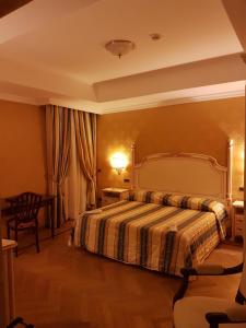 a bedroom with a large bed and a large window at Grand Hotel Villa Balbi in Sestri Levante