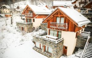 a house with snow on the roof at Odalys Chalet Le Mas des Neiges in Valloire