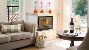 a living room with a couch and a fireplace at Casale Panayiotis in Kalopanayiotis