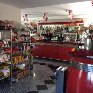 a woman standing at the counter of a restaurant at Caffetteria dell'Angolo in Borghetto Secondo