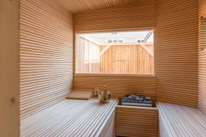 a sauna with a window in a wooden wall at das-hornsteiner in Passau