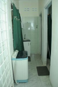 a bathroom with a sink and a washing machine in it at Chalet Anna's Pavalesto in Landsboerderij