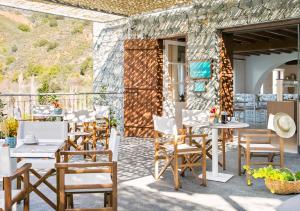 a group of chairs and tables on a patio at Casale Panayiotis in Kalopanayiotis