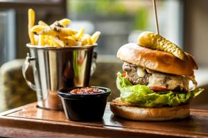 a sandwich and french fries and a bucket of corn on the cob at Best Western Plus Pinewood Manchester Airport-Wilmslow Hotel in Handforth