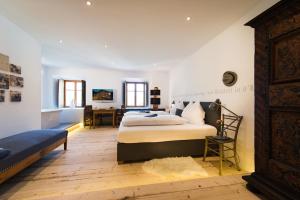 sypialnia z dużym łóżkiem i biurkiem w obiekcie Hotel & Gourmetwirtshaus Kirchenwirt seit 1326 w mieście Leogang +37 zdjęć