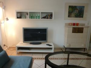a living room with a flat screen tv on a table at Schwarzwald light in Freudenstadt