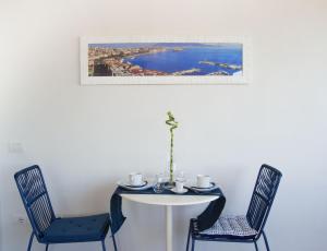 a white table with two chairs and a table with at "Panoramic Terrazza - Napoli" in Naples