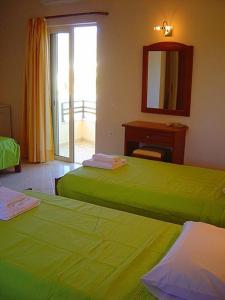 Postel nebo postele na pokoji v ubytování Ostria Hotel