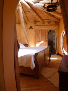 a bedroom with a bed in the middle of a room at Cabane-hobbit de Samsaget in Eyvignes-et-Eybènes
