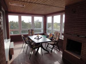 a dining room with a table and chairs and a fireplace at Forsthaus Appartements in Braunschweig