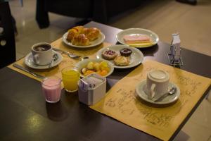a table topped with plates of breakfast foods and drinks at Hotel Las Vegas in Salta
