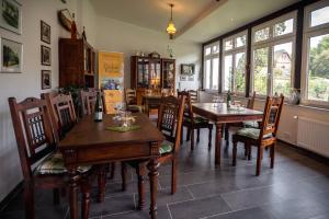 a dining room with tables and chairs and windows at Ferienweingut Göbel in Traben-Trarbach