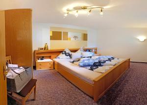 a bedroom with a bed and a chair in it at Appartements Kuprian in Längenfeld