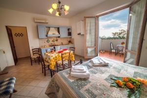 a kitchen and dining room with a table with a table cloth at Casa Vacanze Santa Caterina in Asciano