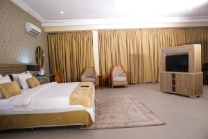 A bed or beds in a room at Heritage Continental Hotel