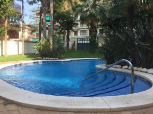 a swimming pool in the middle of a yard at Apartamento en Playa Capellans in Salou