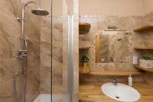a bathroom with a sink and a shower at 1898 Parkside Boutique Residence in Krakow