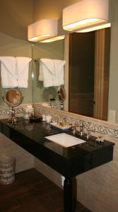 a bathroom with a sink and a large mirror at The Inn at Houmas House Estate in Darrow