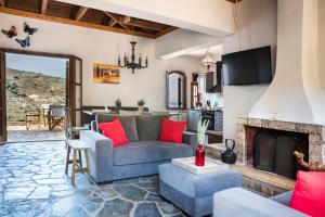 a living room with a couch and a fireplace at Myrtos Bay Apartments in Anomeriá