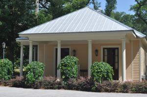a small yellow house with a white roof at The Inn at Houmas House Estate in Darrow