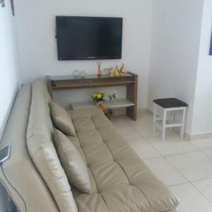 En tv och/eller ett underhållningssystem på Apartamento Praia Grande