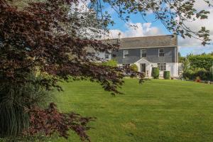 a large house with a large yard in front of it at Treweens in Wadebridge