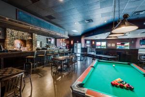 a pool table in a restaurant with a bar at Heritage Inn Hotel & Convention Centre - High River in High River