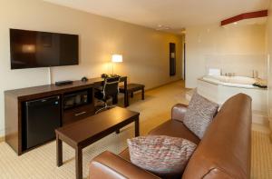 a living room with a couch and a tv and a sink at The Kanata Inns Invermere in Invermere