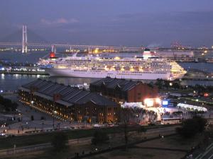 a cruise ship is docked in a harbor at night at Navios Yokohama in Yokohama