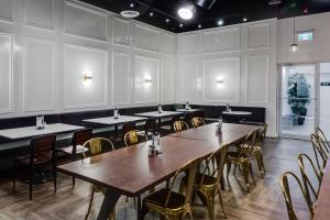 a room with tables and chairs in a restaurant at Heritage Inn Hotel & Convention Centre - Brooks in Brooks