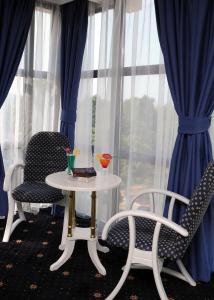 a table and chairs in front of a window at Millenium Palace in Ohrid