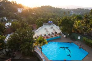 a swimming pool with a surfboard on top of it at Swiss Residence Kandy in Kandy