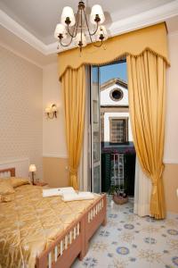 a bedroom with a large bed and a large window at Olimpo degli Dei in Naples