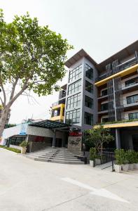 a large building with stairs in front of it at Samkwan Village in Bangsaen