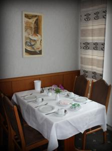 una mesa con un mantel blanco. en Hotel Alina en Wiesbaden