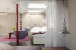 a bedroom with a bed and a table and a chair at Bed & Office 050 in Groningen