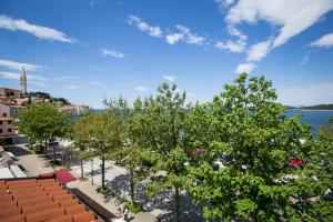 a view of a city with trees and the water at Valdibora Sea View Residence in Rovinj