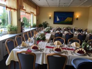 a conference room with long tables and chairs at Hotel Kieler Förde & Free Parking in Kiel