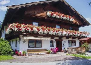 a house with flowers on the front of it at Bauernhof Hinterfirst in Söll