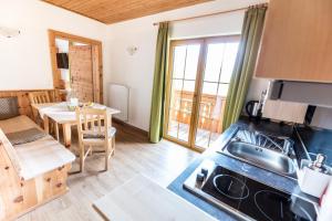 a kitchen and dining room with a table and a stove at Der Hoferbauer in Bad Kleinkirchheim