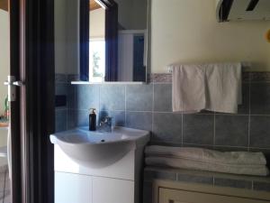 a bathroom with a sink and a mirror at Full comfort flat west sicily in Marsala