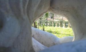 a view through a hole in a rock formation at Hotel Happy Days in Licola