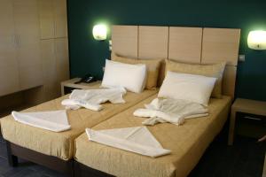 Ein Bett oder Betten in einem Zimmer der Unterkunft Sirena Residence & Spa